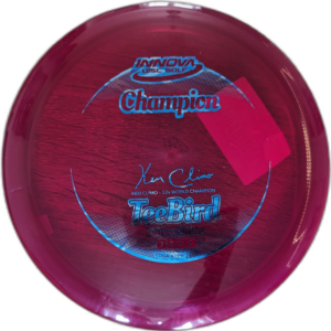 Champion Teebird from Innova. Colour is Maroon with a silver and blue stamp.